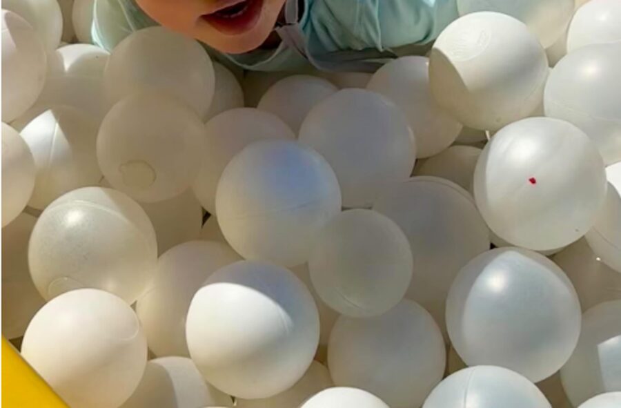 Toddler playing in the kids' play area ball pit at The Triangle at Little River