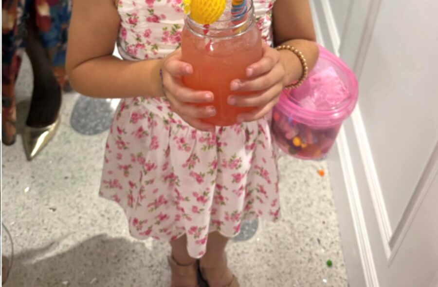 Young girl at The Triangle at Little River holding a colorful non-alcoholic tot-tail drink